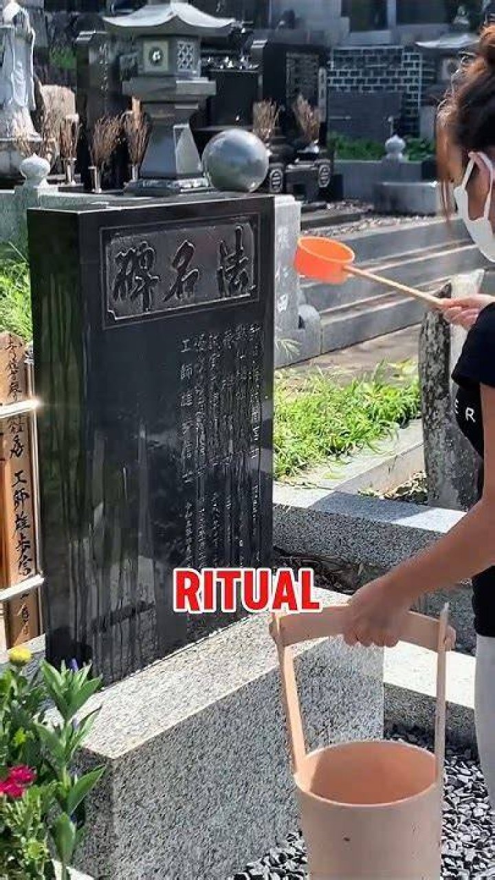 Why do the Japanese pour water on graves?
